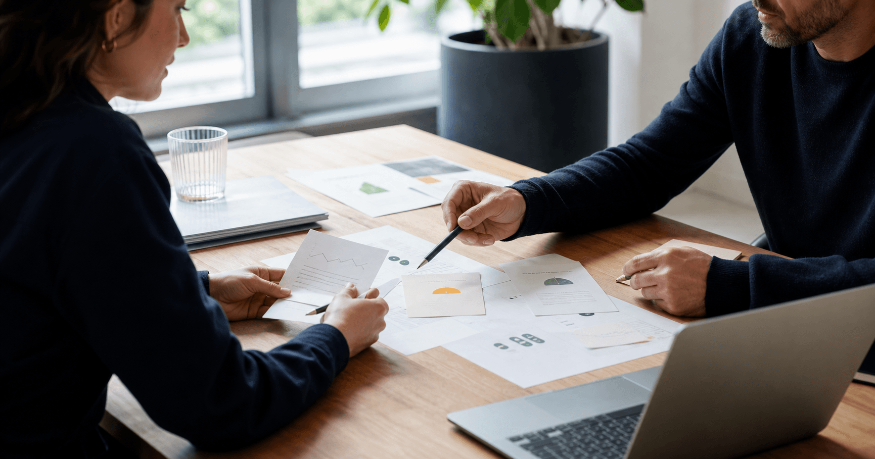 Founder and advisor reviewing startup bottleneck evidence at a table